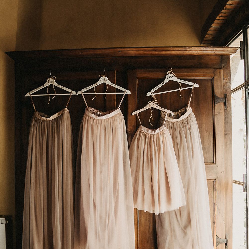 Neutral pink toned tulle bridesmaids skirts hanging up