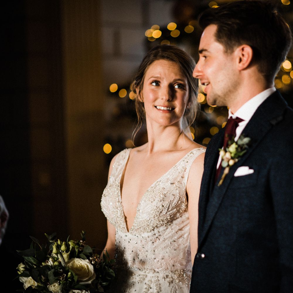Bride looks at groom during wedding ceremony