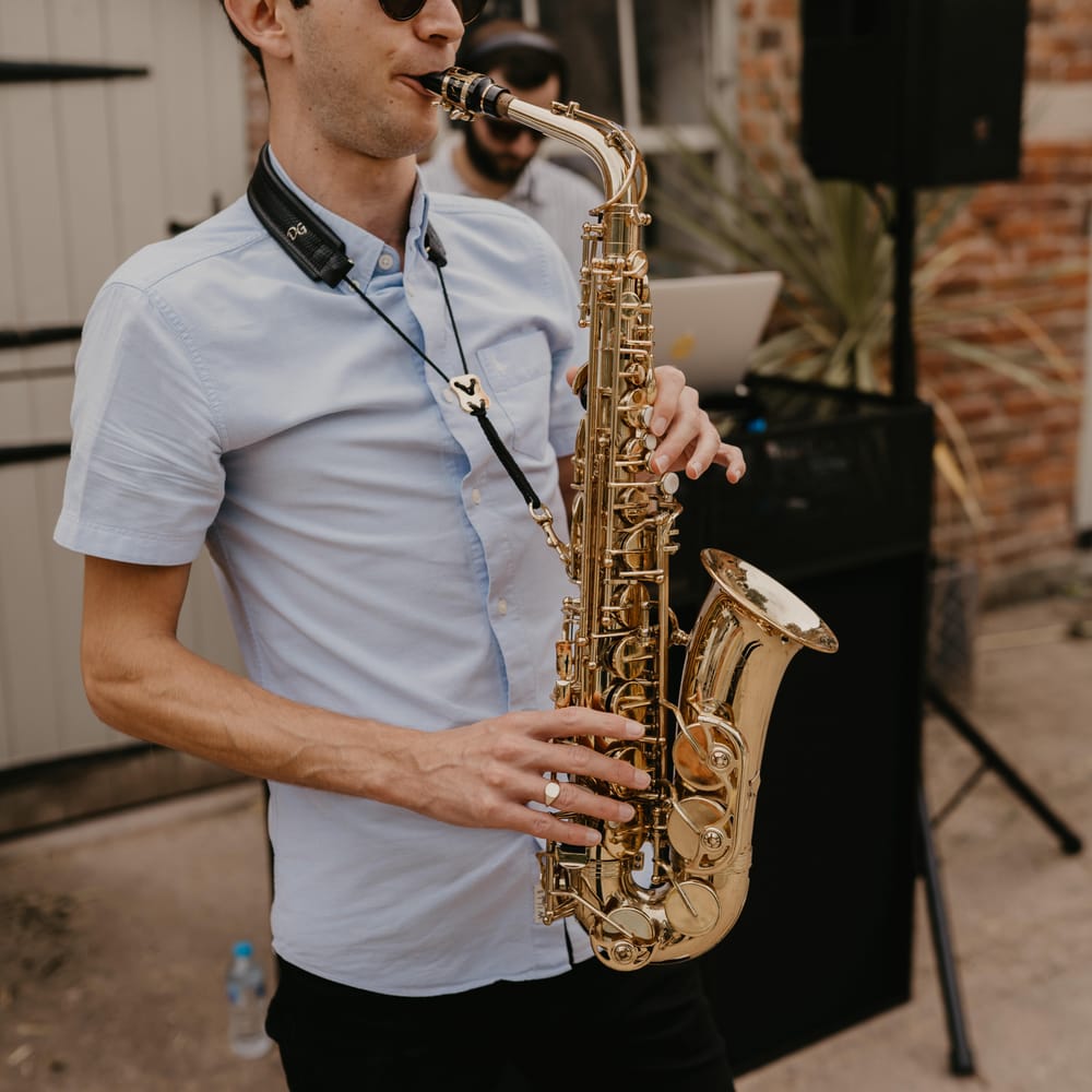 Saxophone player during beginning of wedding reception | Mark Bamforth Photography