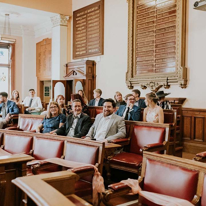 Wedding guests await bride & groom during ceremony