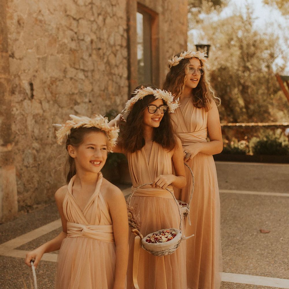 Flower girls wear neutral gowns and flower crowns