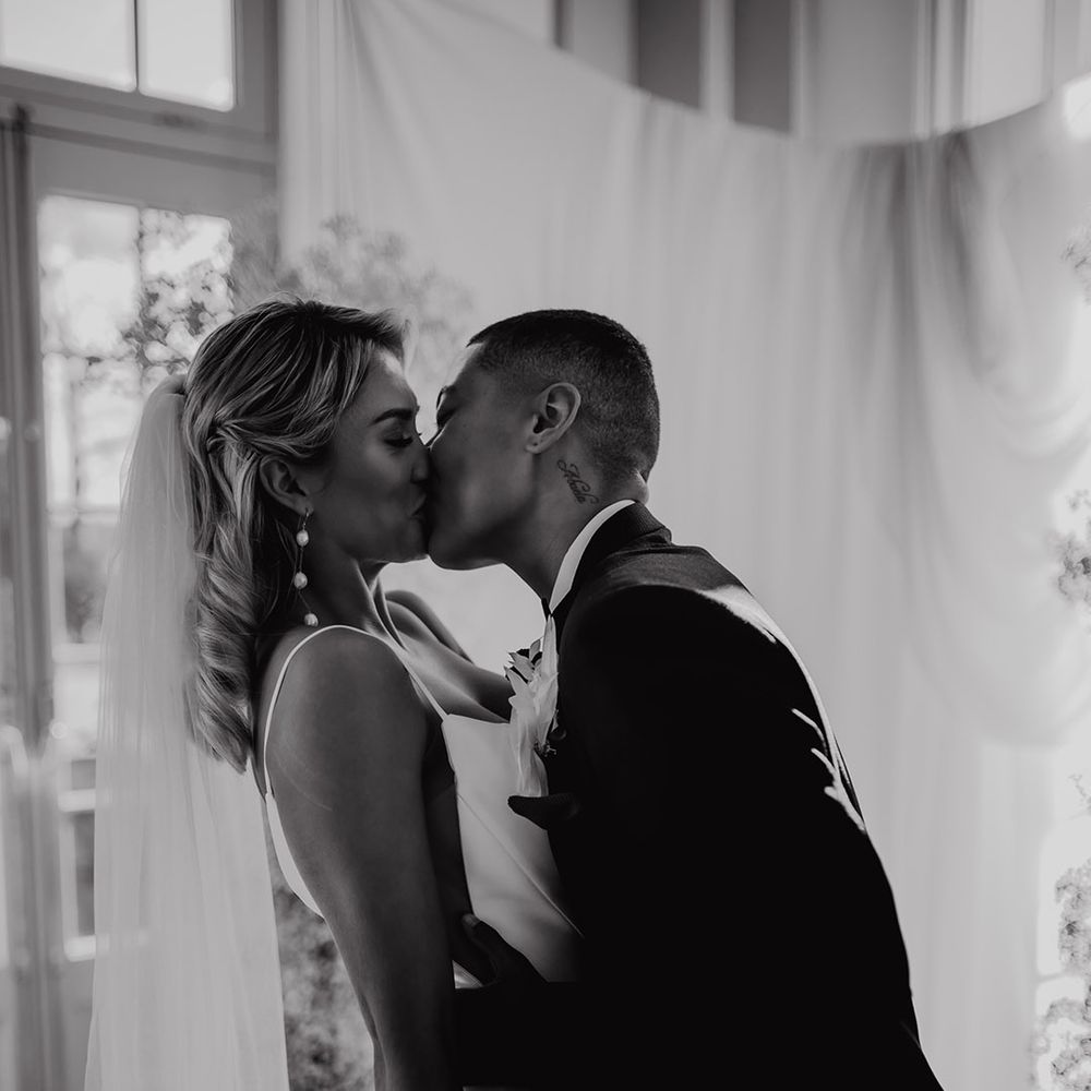 LGBTQI+ couple kissing at their Hodscok Priory wedding ceremony 