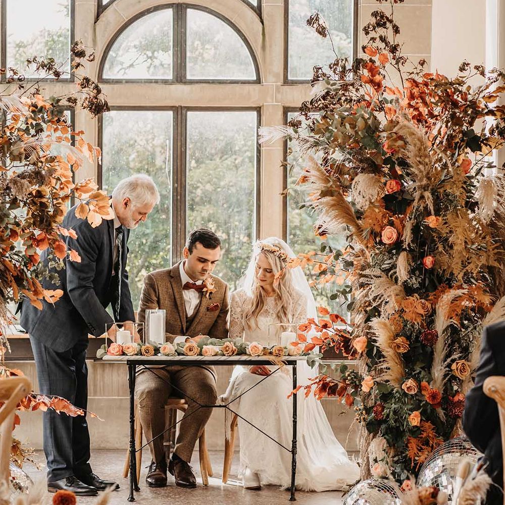 Boho Scottish Civil wedding ceremony with orange and dried grass column wedding flowers 