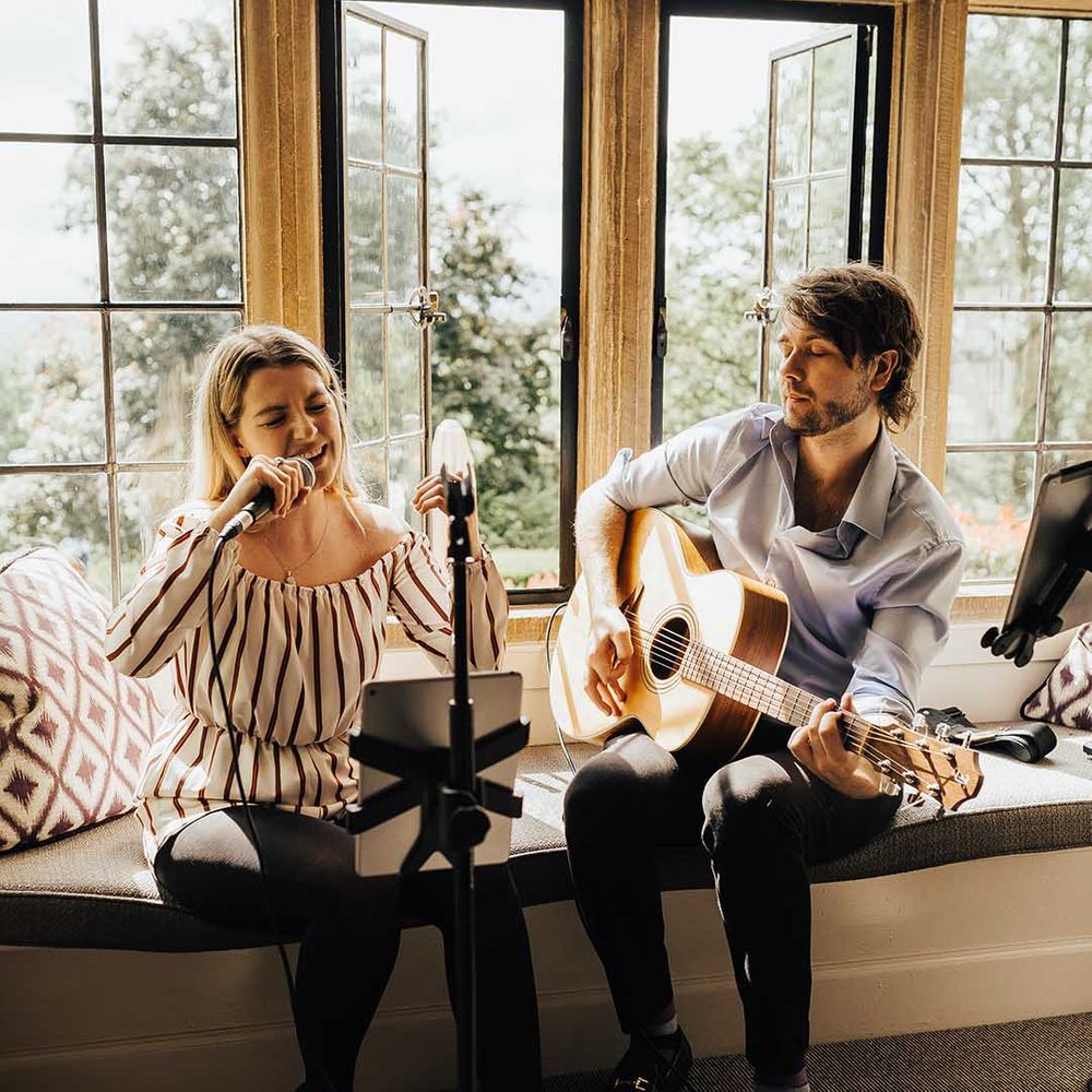 Guitar and vocalist playing and signing at the wedding reception at a luxury Foxhill Manor wedding