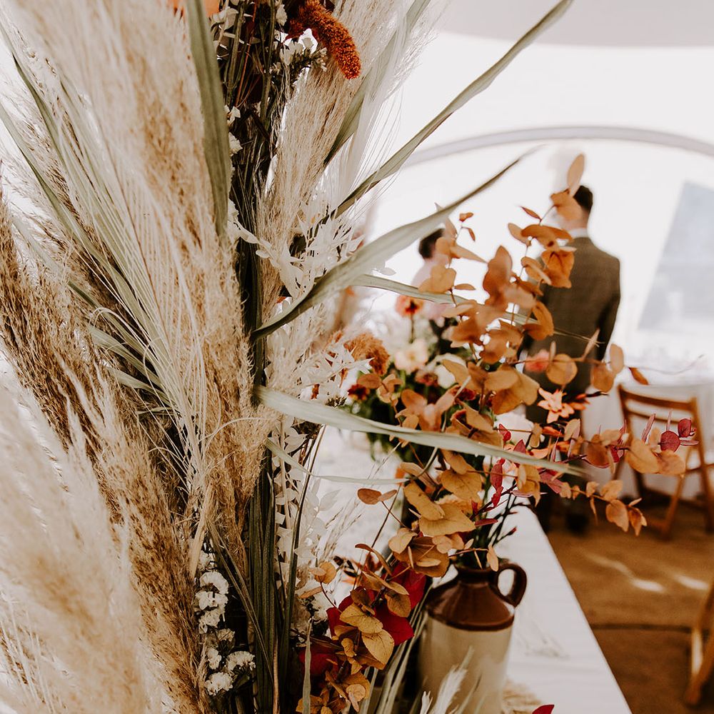 Dried pampas grass and Autumnal coloured florals for boho styled wedding day
