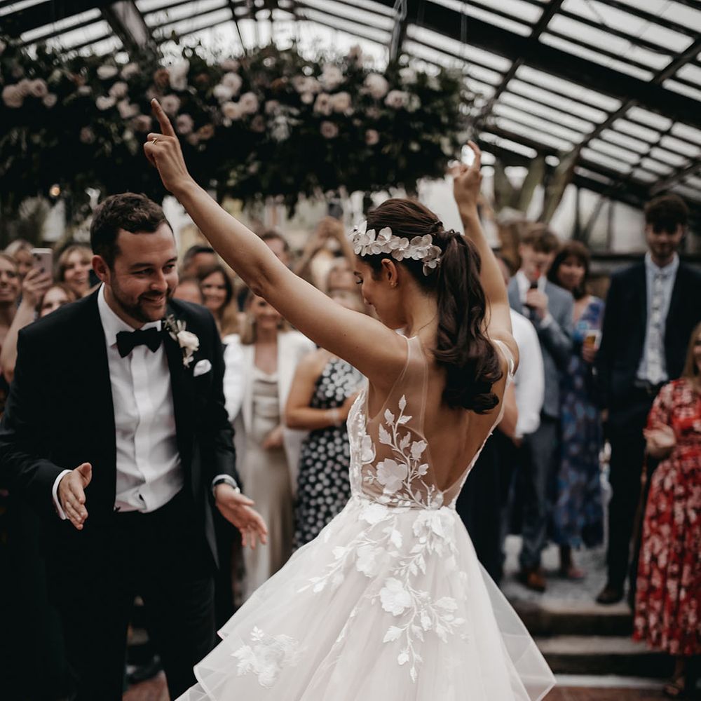 The bride and groom share their first dance together as the guests watch on 