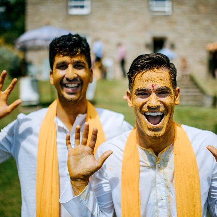 Grooms covered in Haldi paste for Hindu & Punjabi wedding tradition 