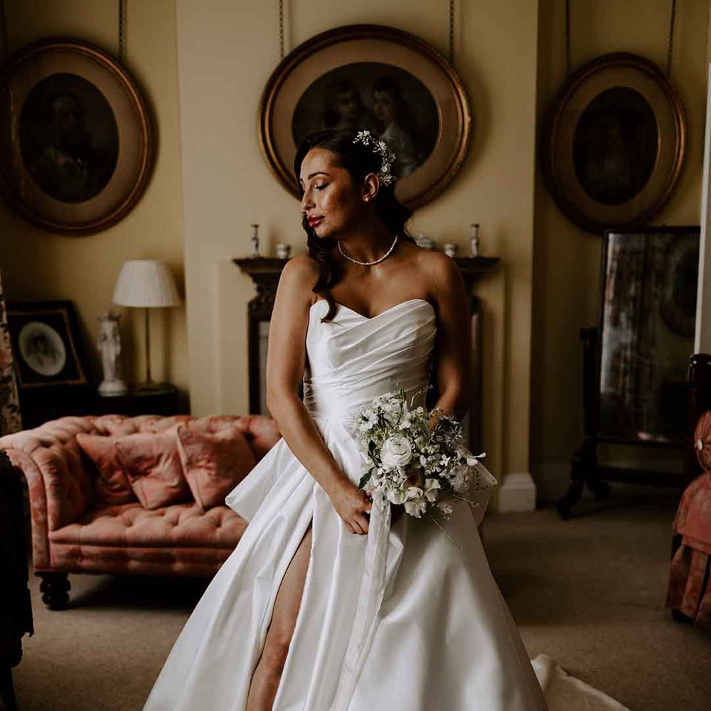 Bride in a strapless wedding dress with front slit 