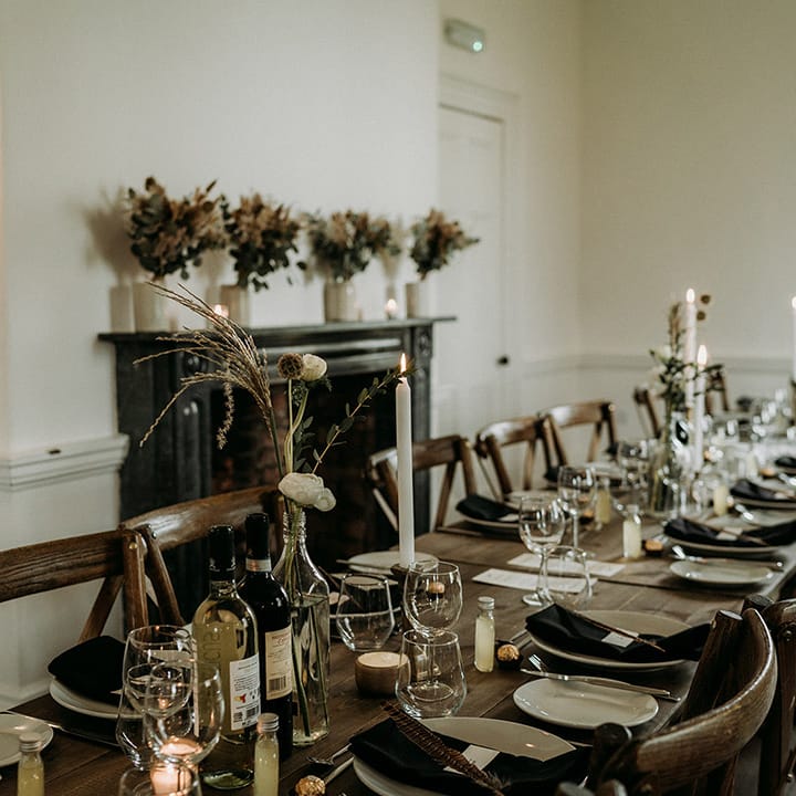 Simple, neutral and minimal wedding tablescape with white flowers and candles 