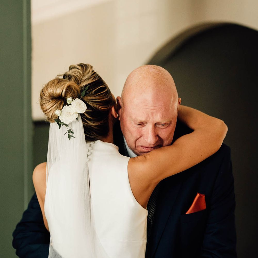Father of the bride tears up as he sees the bride for the first time ready for the wedding day 