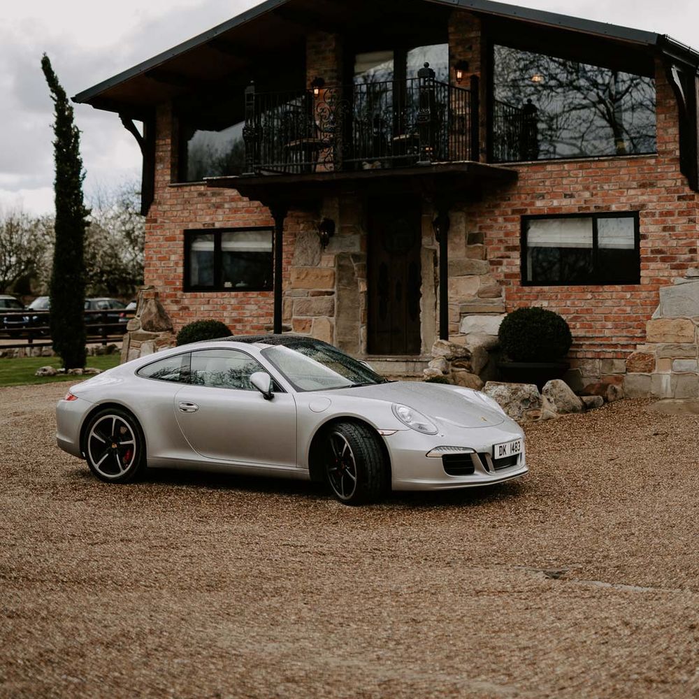 Willow Marsh Farm Loughborough wedding venue with silver wedding sports car 