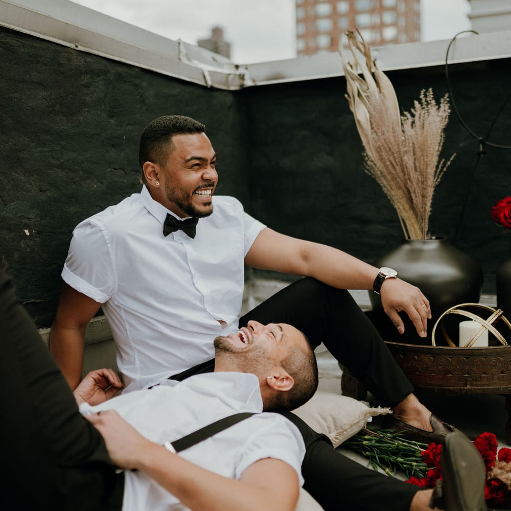 Grooms share a smile at intimate gay wedding New York 