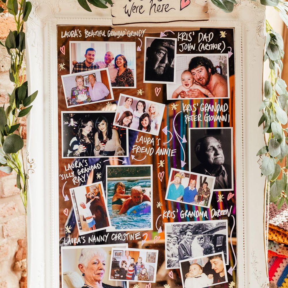 Remembrance wedding mirror on easel with photos, leaf garland and sign reading 'wish you were here'