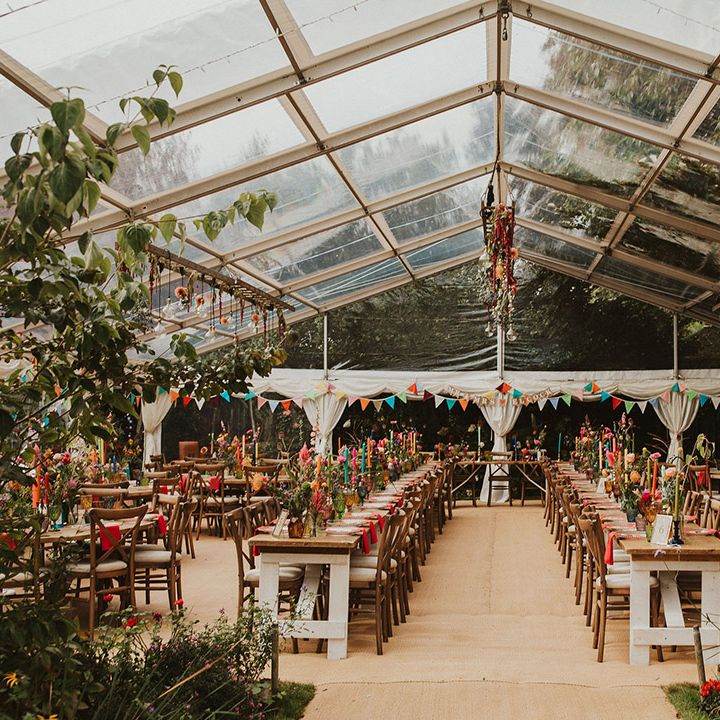 clear span marquee wedding reception with glass roof and colourful wedding table decor 