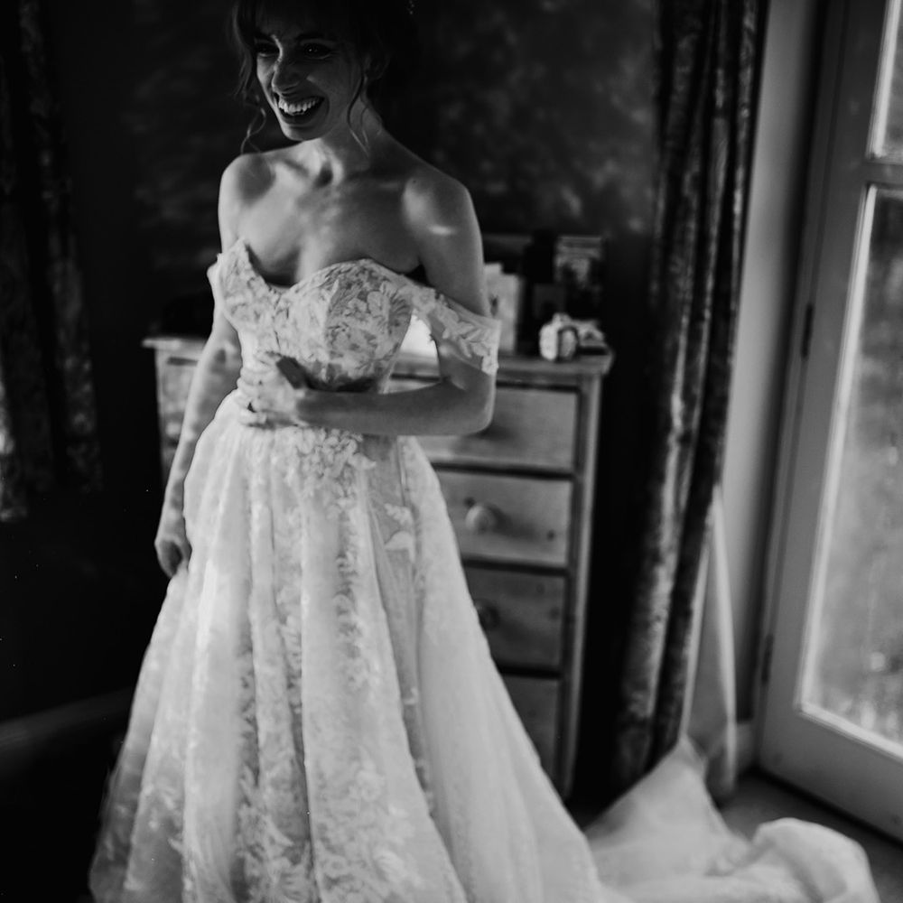 Bride smiles in her lace wedding dress