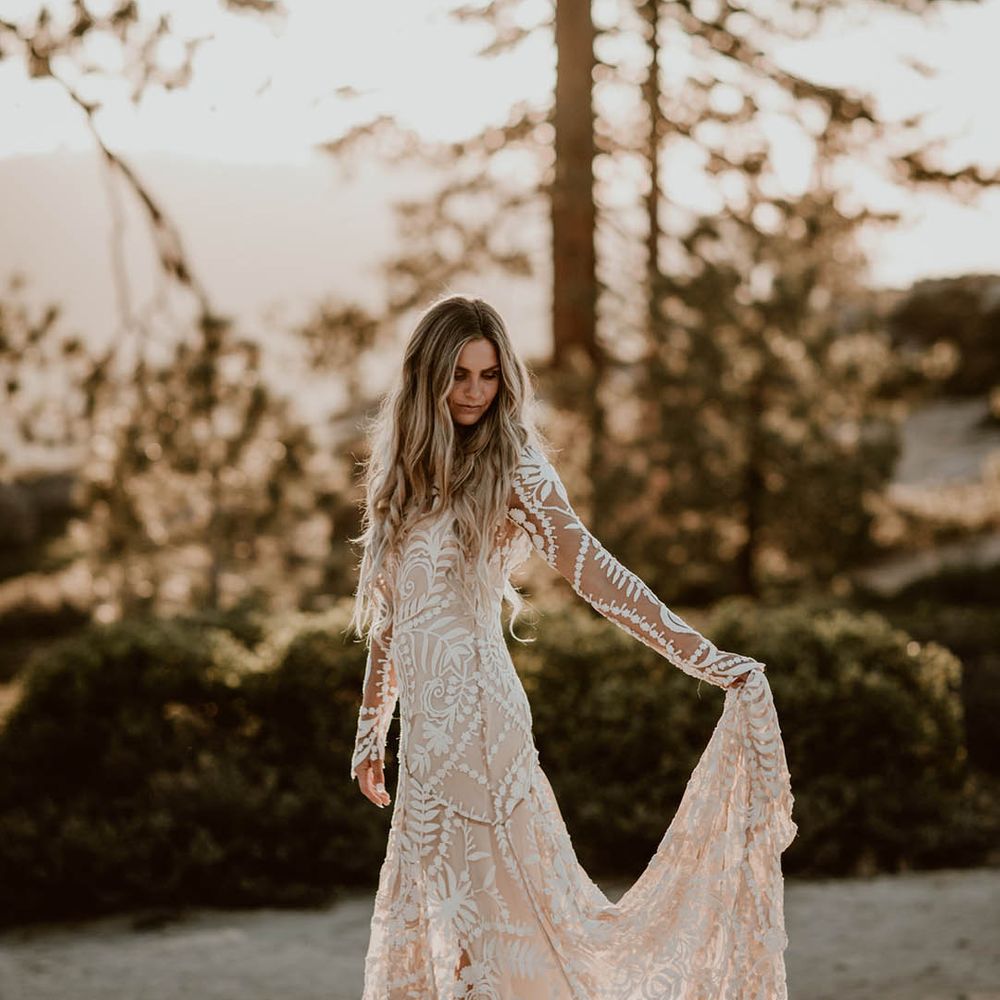 Bride holds the train of her dress on her wedding day
