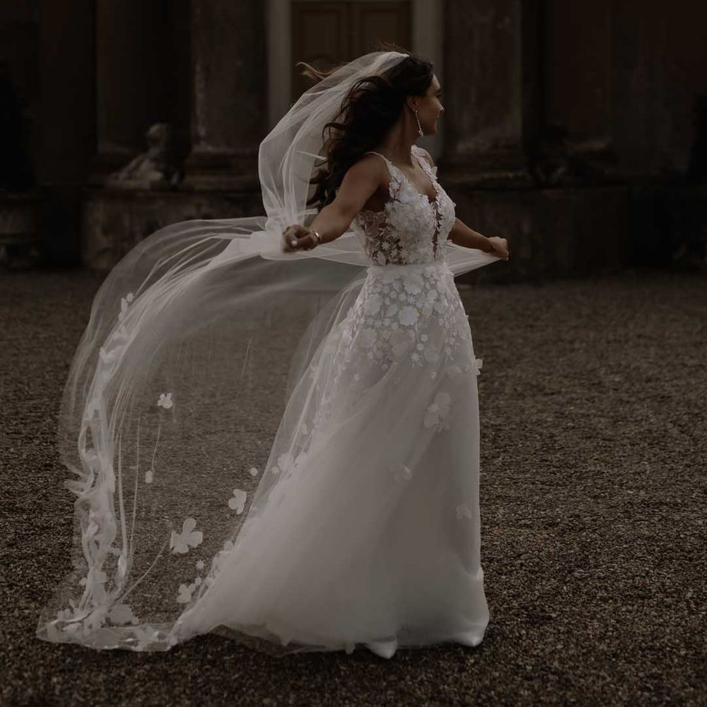 Bride Mira Zwillinger wedding dress with floral embroidered veil for outdoor wedding 
