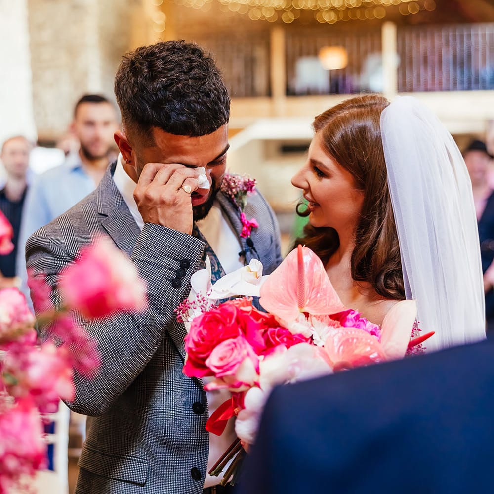 Groom becomes emotional has his bride reaches him once she has walk down the aisle at Priston Mill 