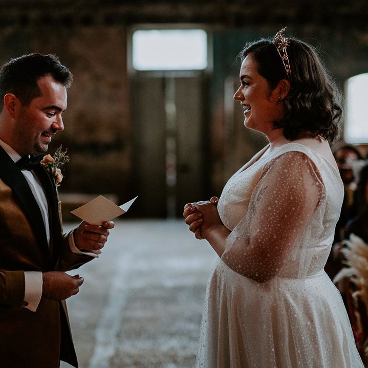 Groom reads vows to Bride at industrial wedding venue in London