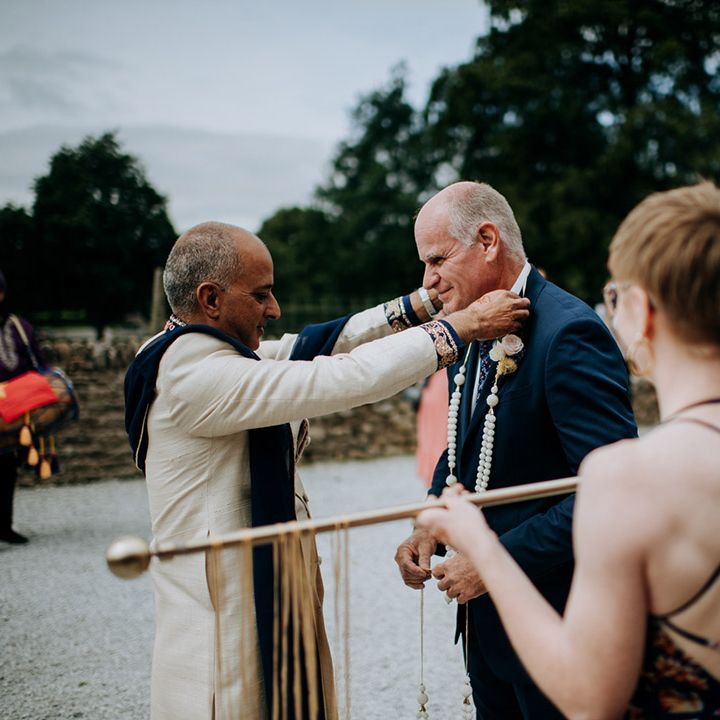 Grooms families come together during wedding ceremony 