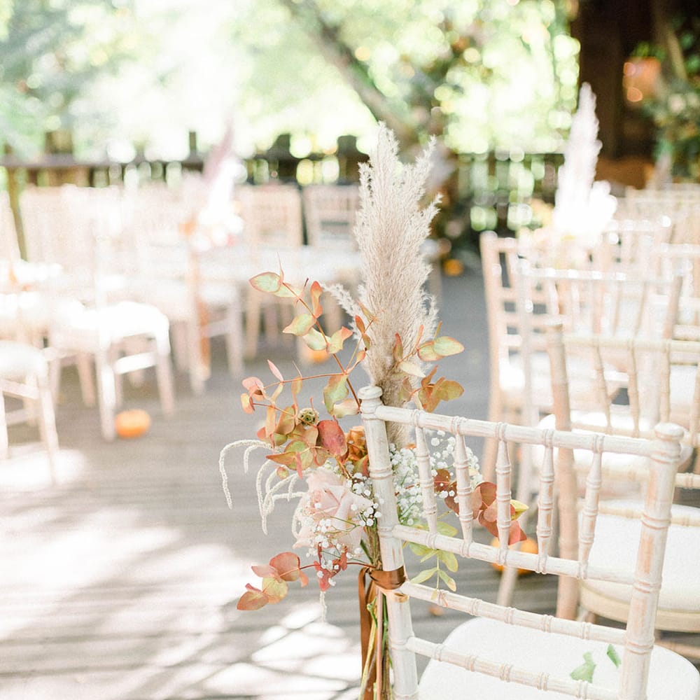 Dried floral arrangement tied to white wicker chair at the Alnwick Garden Treehouse