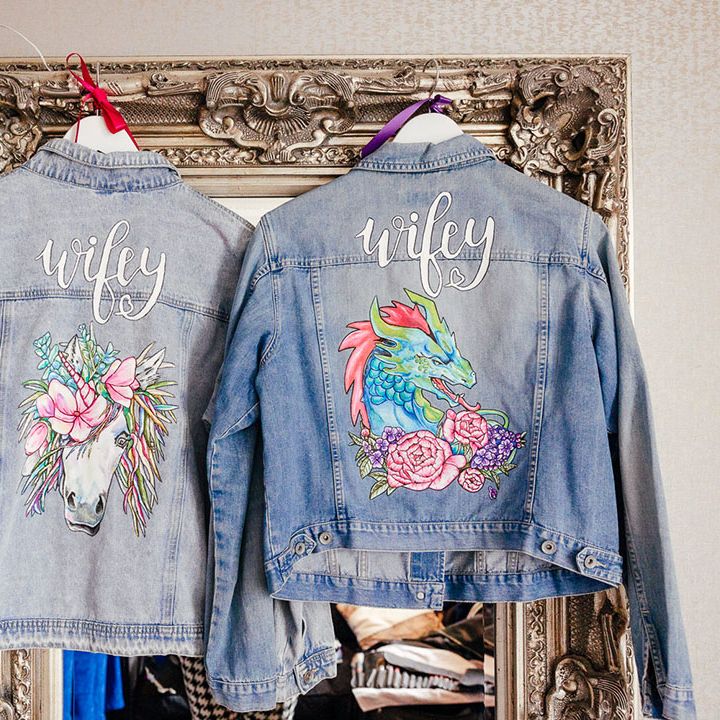 Two bridal personalised denim jackets with embroidered "wifey" lettering with a colourful unicorn and dragon embroidery 