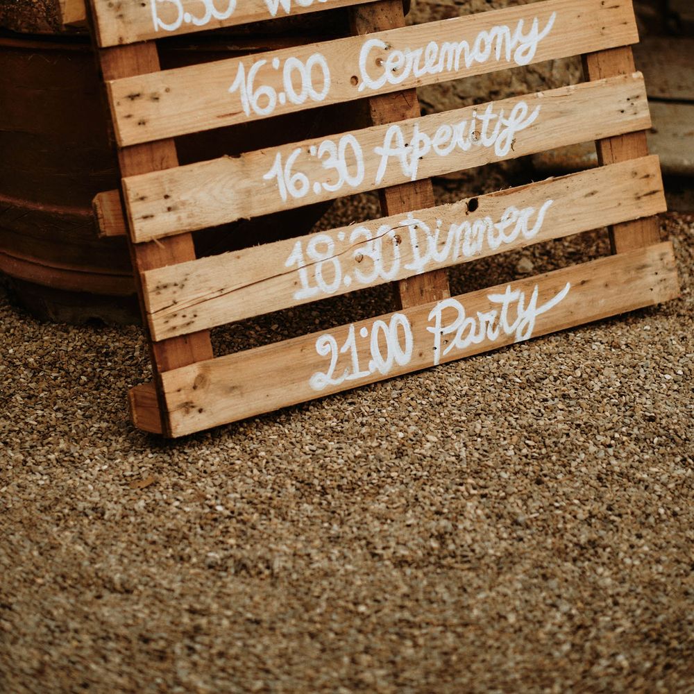 Rustic pallet order of day signage at destination wedding Italy 