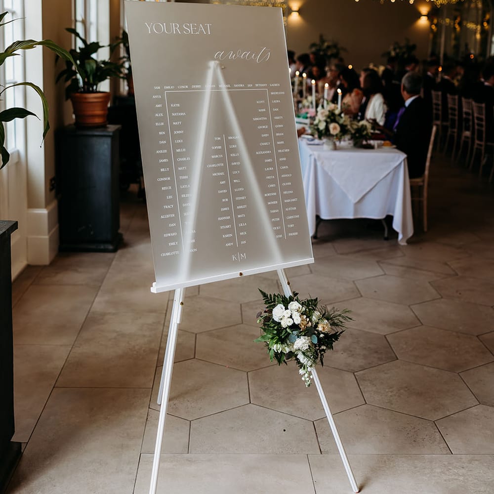 Frosted perspex wedding seating chart signage for classic black tie LGBTQIA+ wedding 
