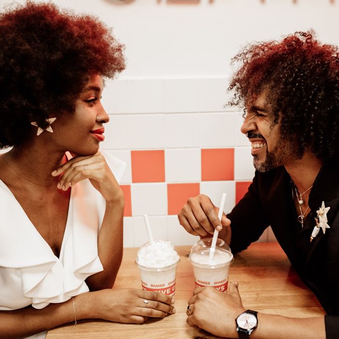 Bride & groom sit in booth at Five Guys