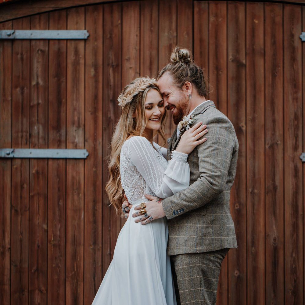 Boho bride with groom wearing a tweed three piece suit