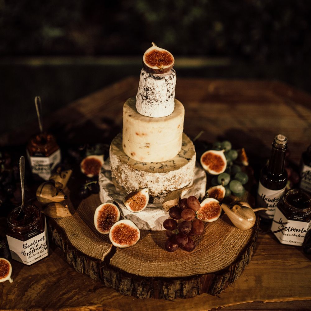 Cheese tower for wedding reception on wooden table 