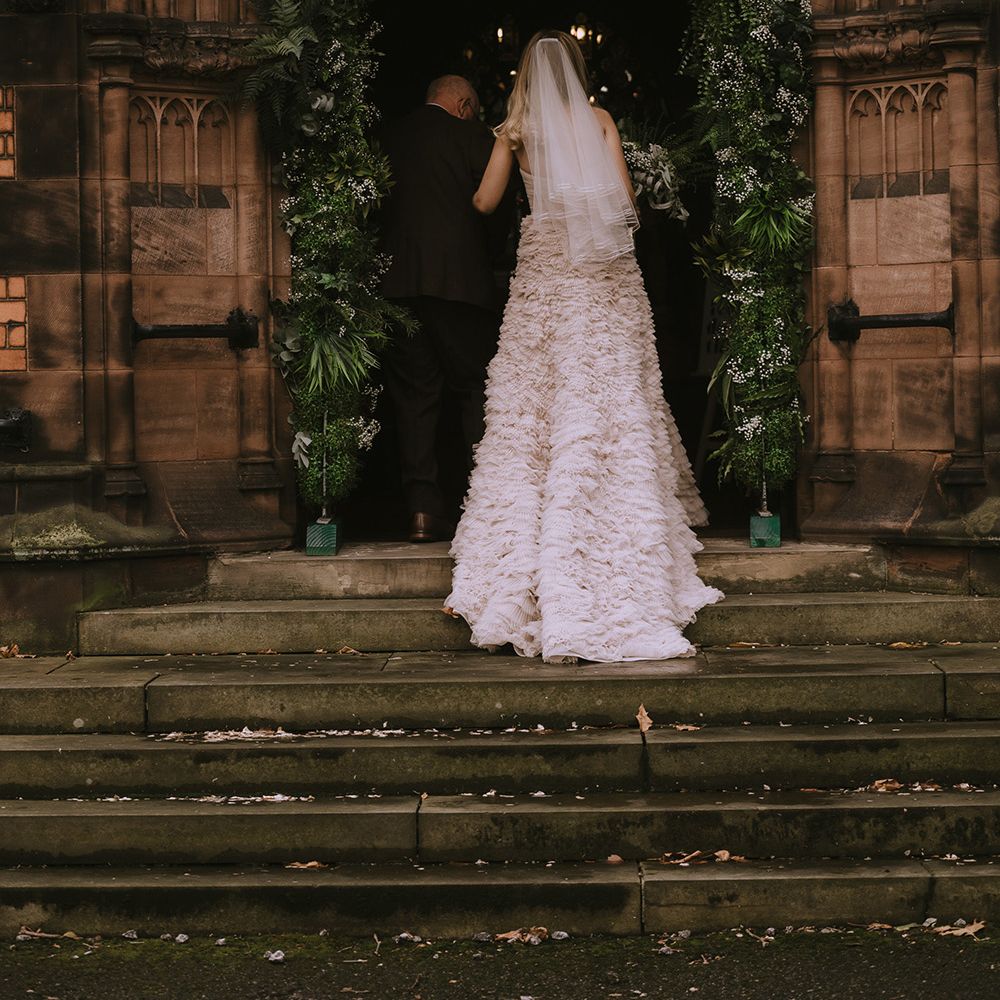 Bride enters church in Watters blush wedding dress