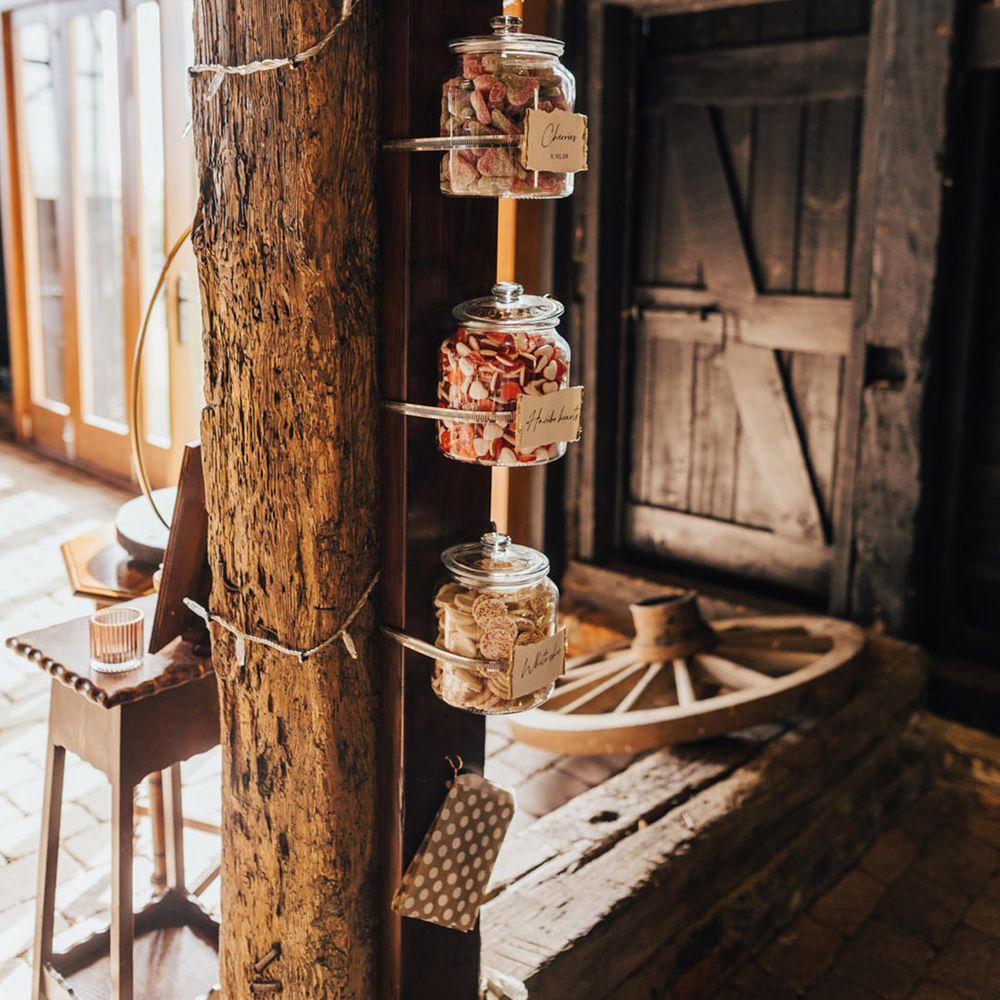 Barn wedding with sweetie jars for guests at Elmley Nature Reserve