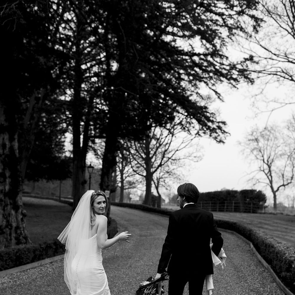 Bride & groom walk with one another on their wedding day 