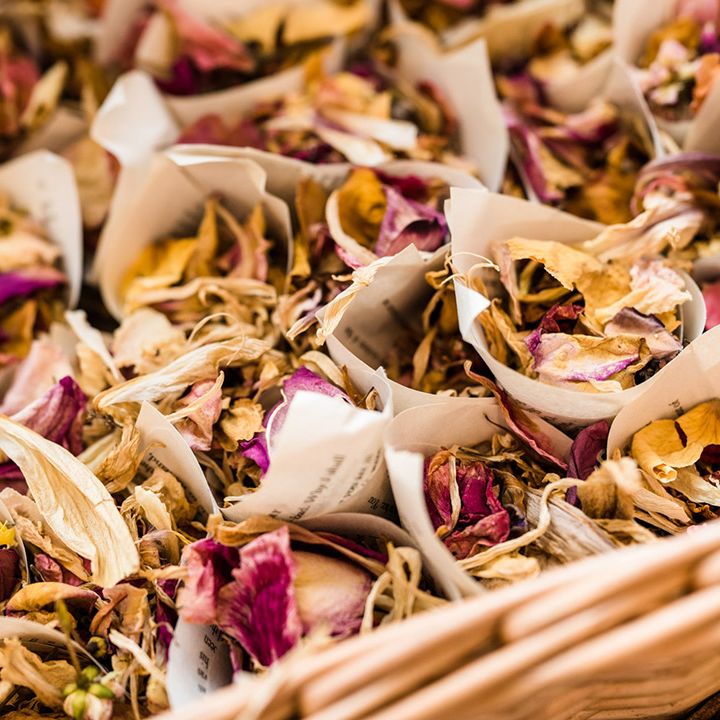 Dried flower autumnal wedding confetti in paper holders for wedding guests to throw