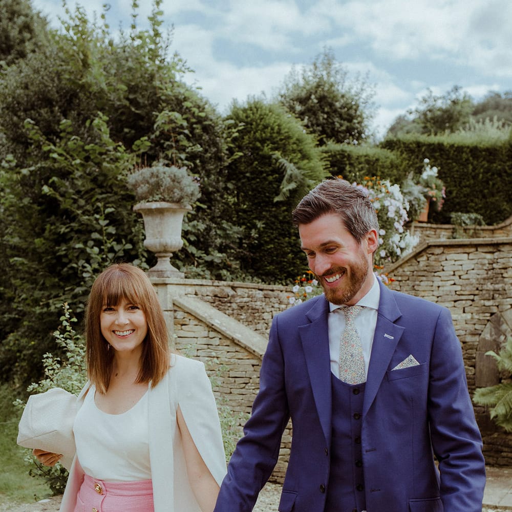 Wedding guest fashion with a bright pink skirt and fun patterned tie