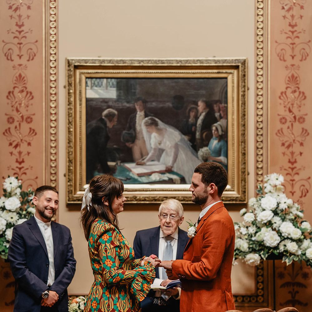 Bride & groom wear brightly coloured outfits on their wedding day during Registry Office wedding ceremony in Bristol 