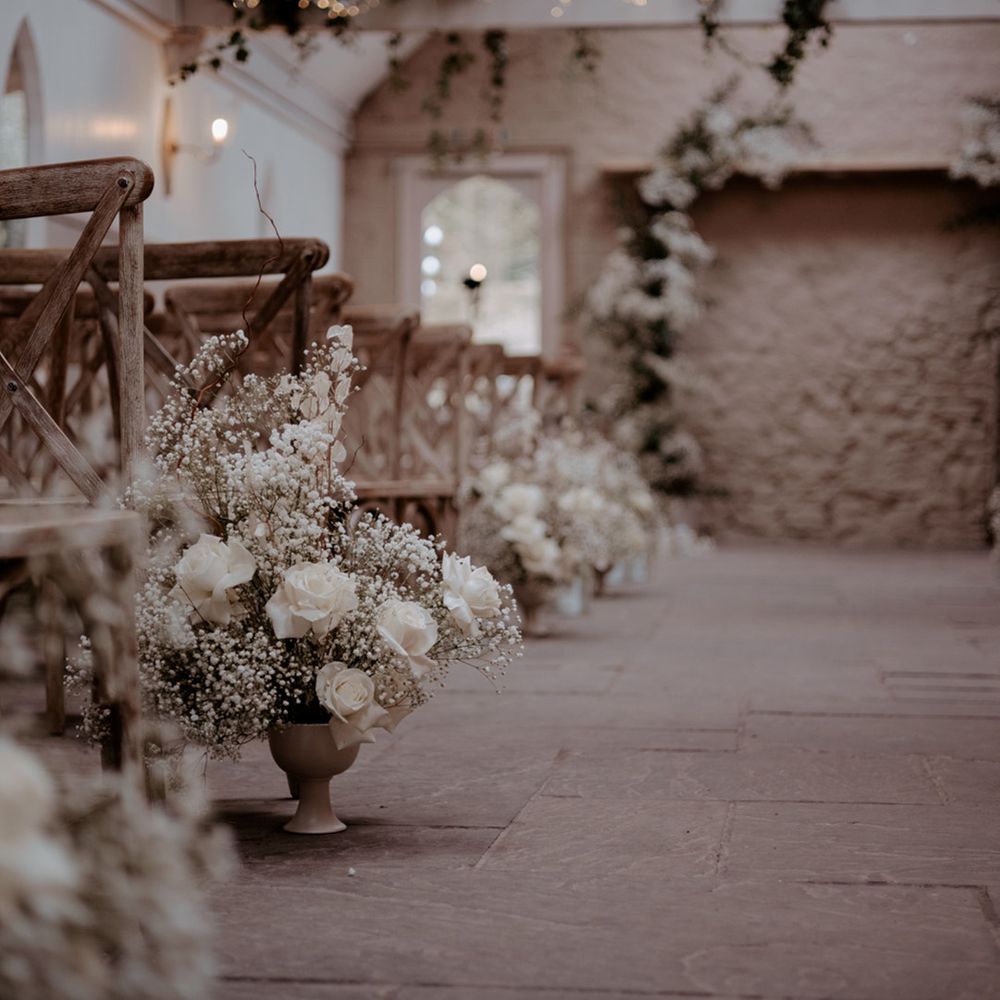 All white wedding flowers and aisle decorations for the classic luxe wedding at Wyresdale Park 