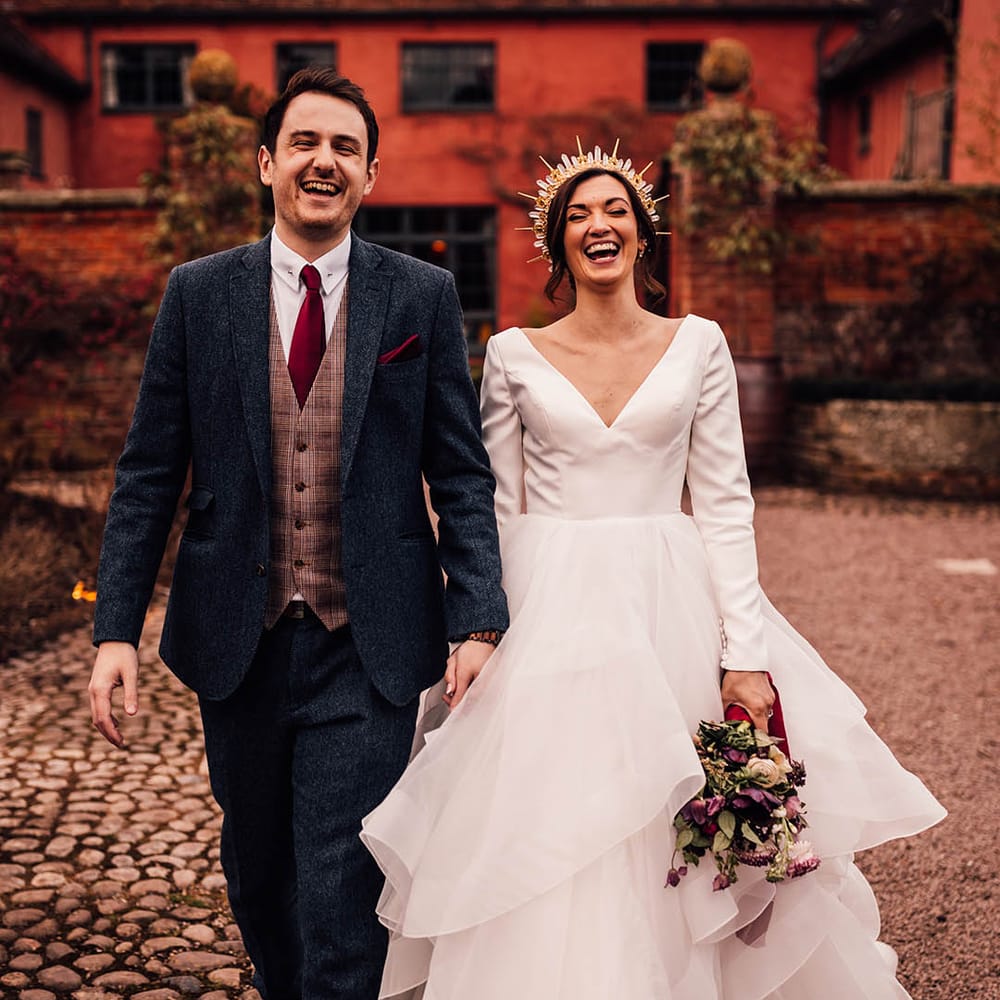 Micro wedding at Pauntley Court country house wedding venue with the bride and groom walking around for their couple portraits 