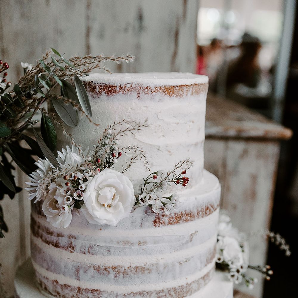 Three tier semi naked wedding cake with white icing for classic and contemporary wedding 