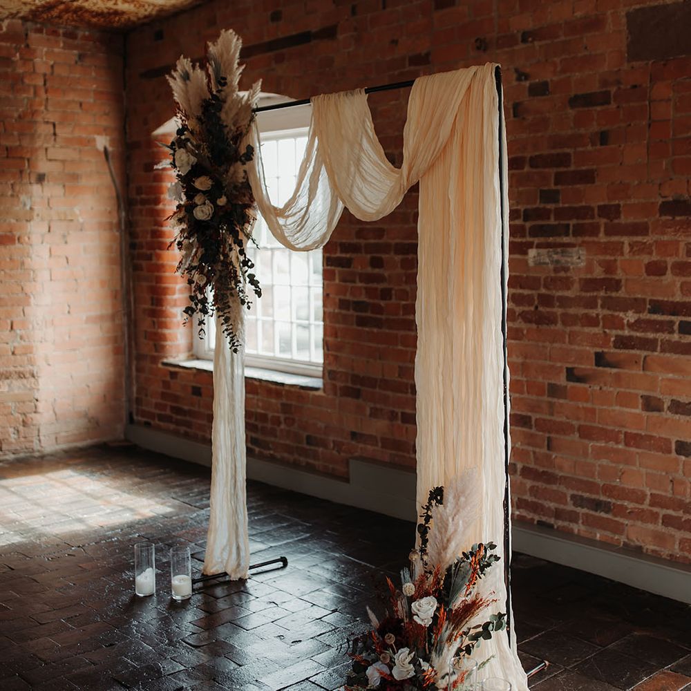 Boho wedding at The West Mill with altar decorations with dried wedding flowers including pampas grass and white roses 
