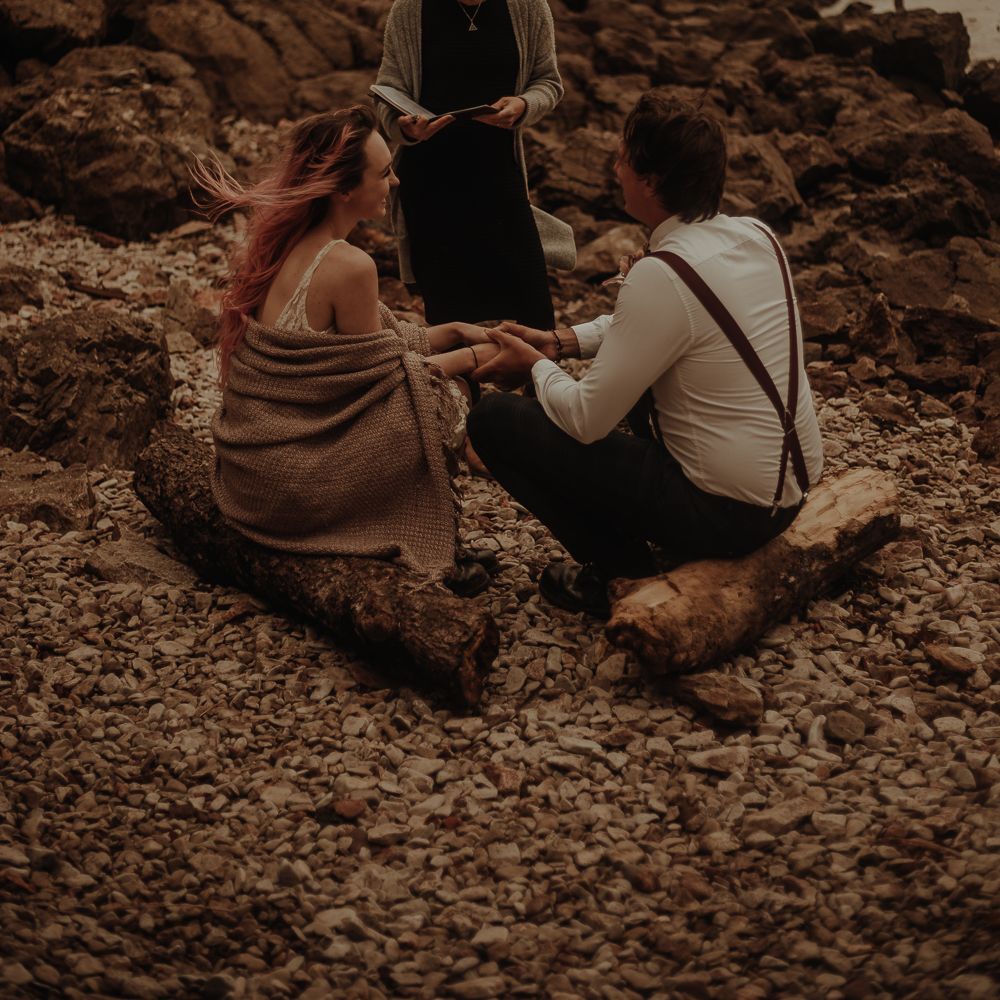 Bride and groom exchanging vows on the beach