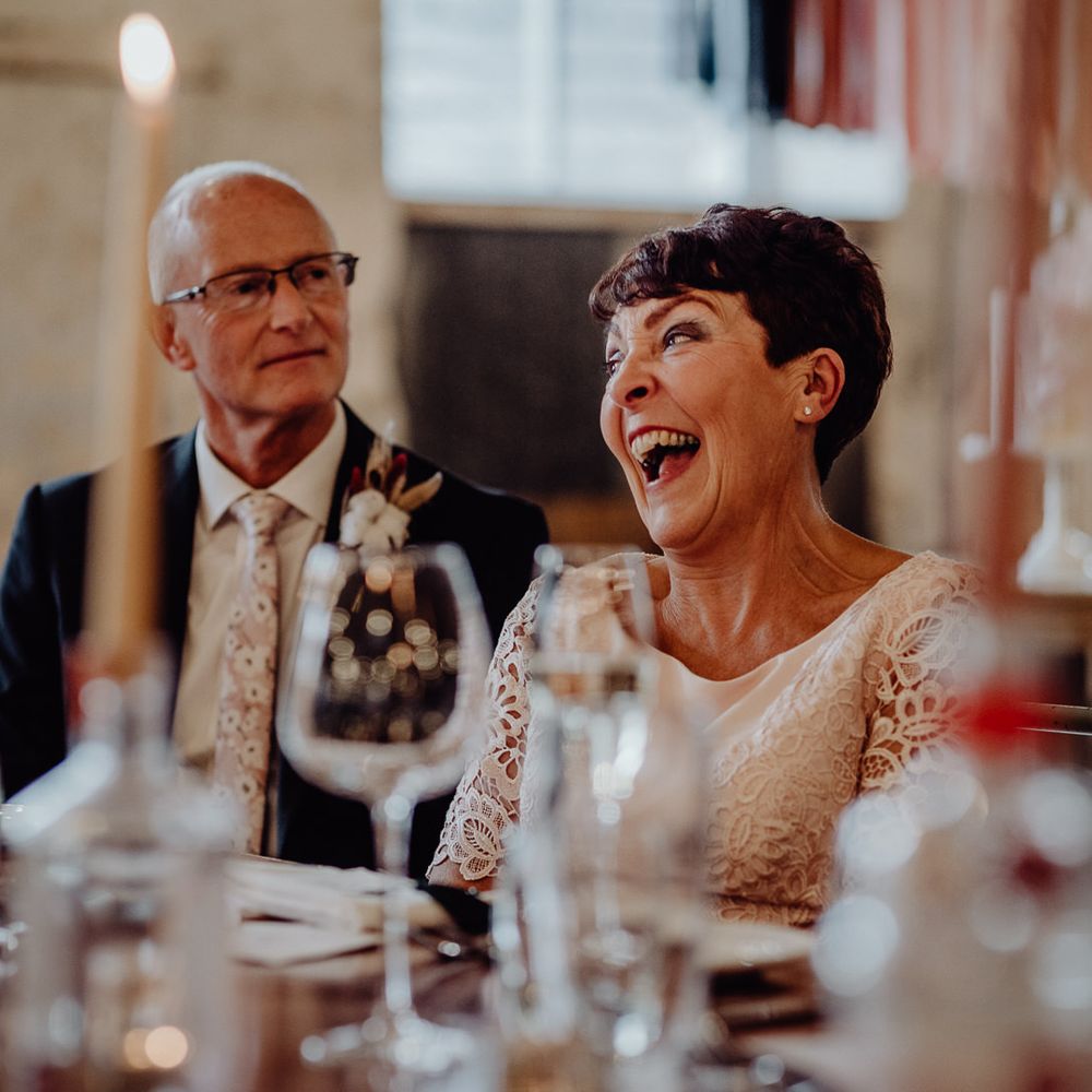 Wedding guests laughing during the speeches