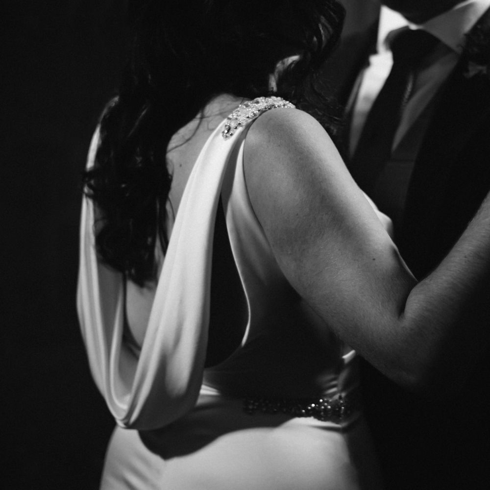Black & white image of bride and groom dancing