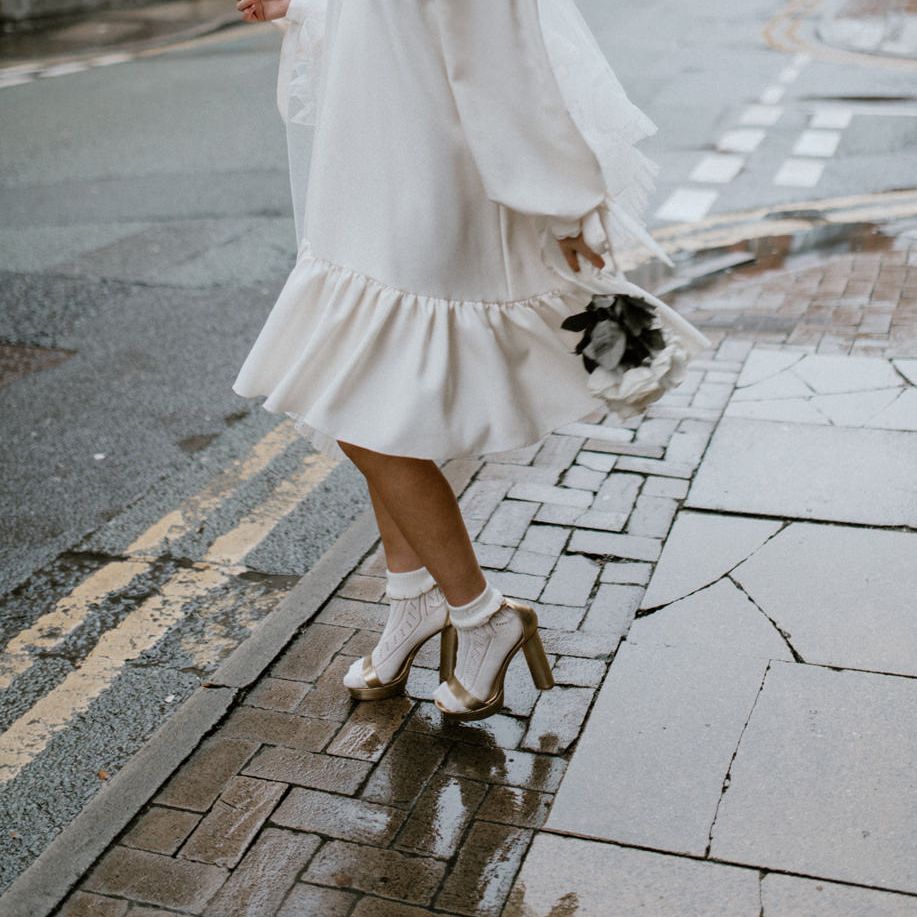 Stylish bride in a loose fitting knee length dress by Moon Child Bridal and Jean Jackson Couture 