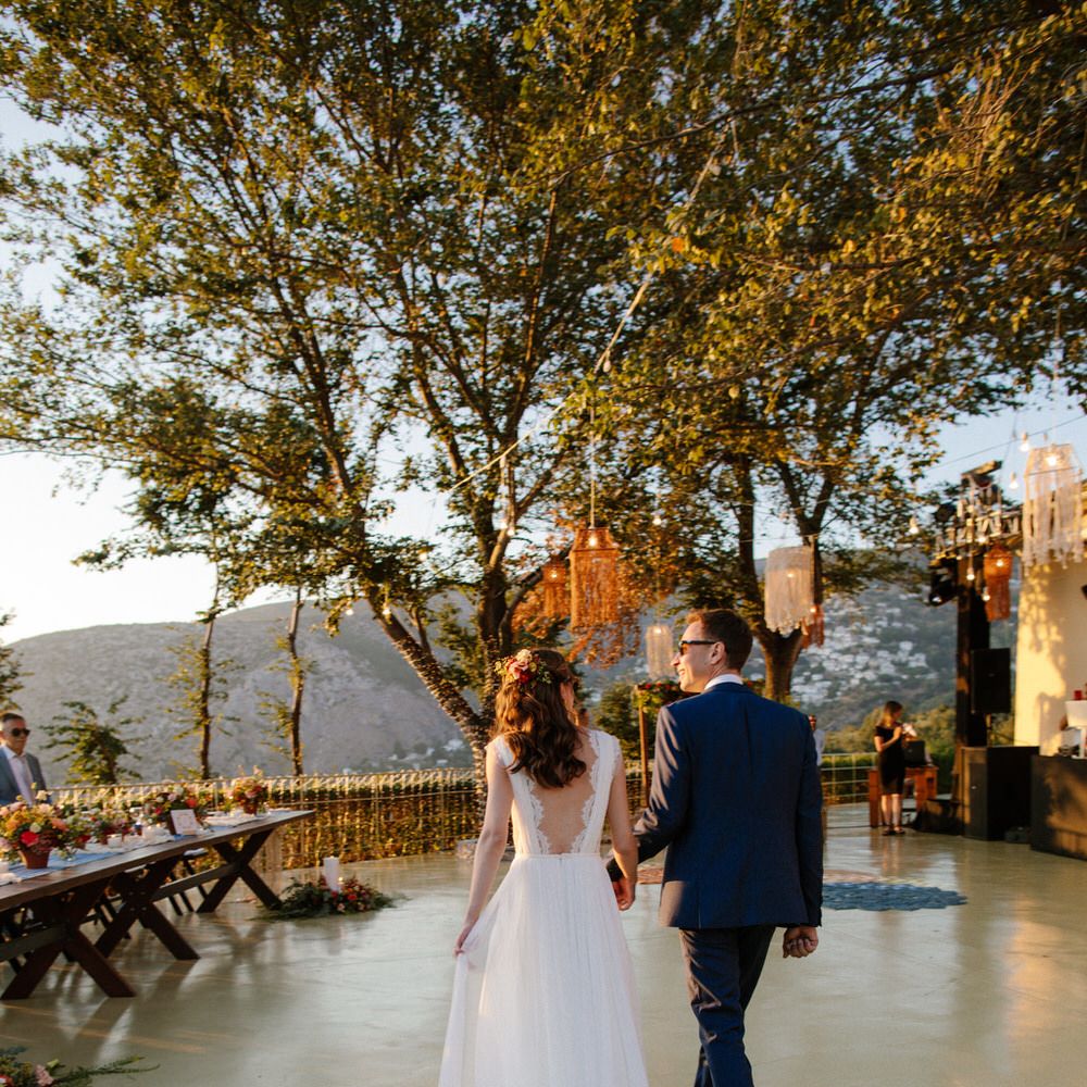 The bride and groom entering their destination wedding reception in Greece