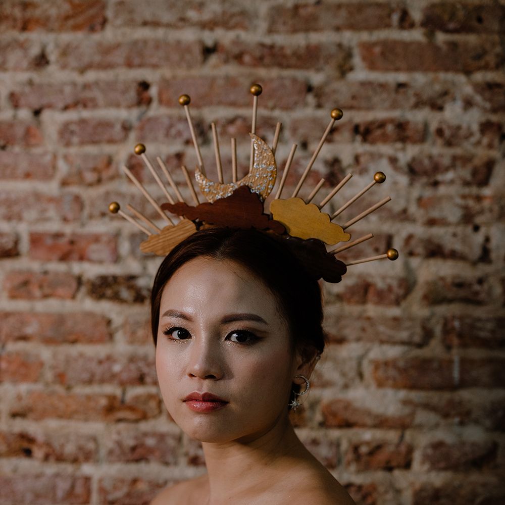 Beautiful Asian bride in a moon and clouds headdress with shimmering eyeshadow