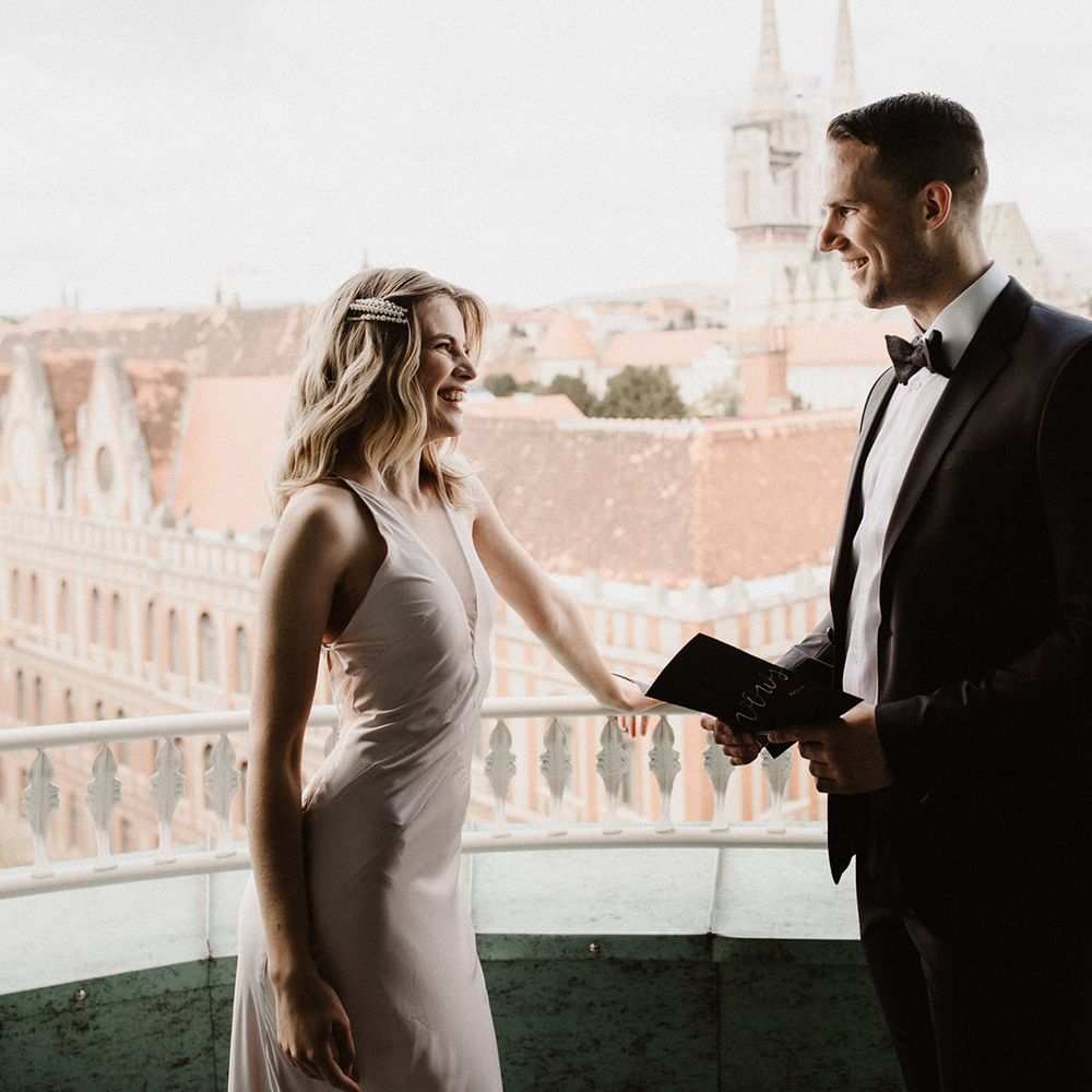 Bride and groom reading their wedding vows on a balcony at Amadria Park Hotel in Croatia