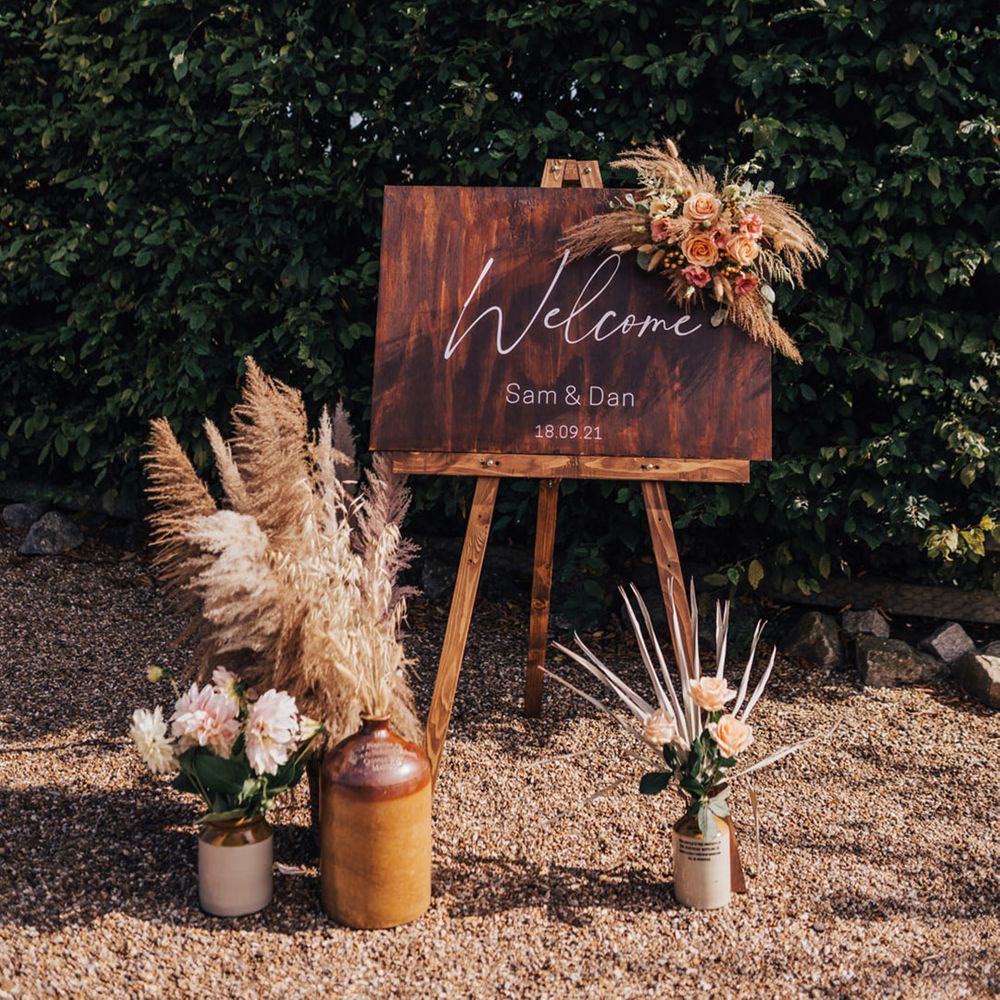 Wooden welcome signage with Pampas grass installation 