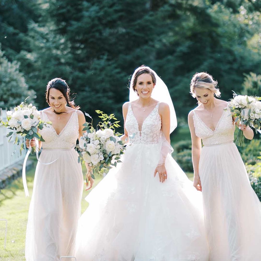 Bride in a princess wedding dress and bridesmaids in needle and thread white bridesmaid dresses 